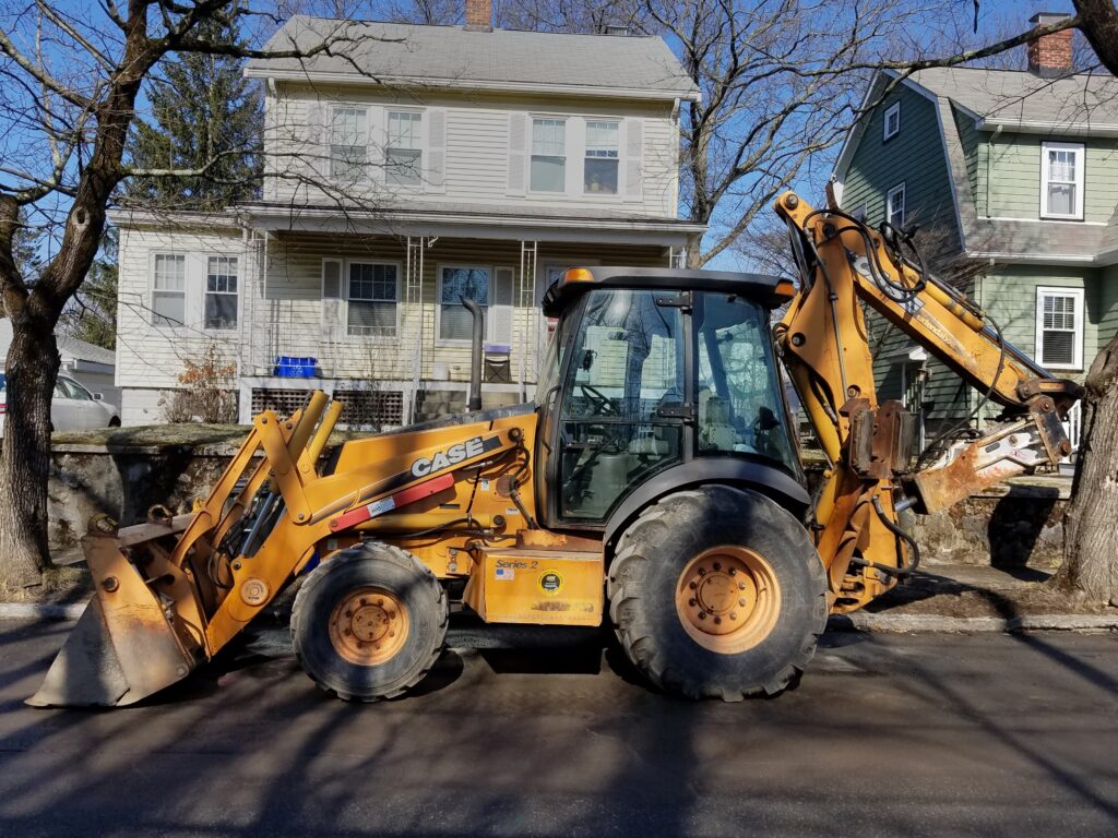 Case backhoe loader on a utility job