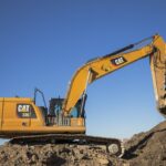 Caterpillar 330 excavator working on a pile of dirt