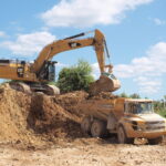 Caterpillar 352F excavator loading an articulated dump truck