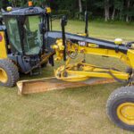 Caterpillar motor grader with moldboard and front push blade