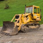 Crawler loader with steel tracks and front bucket