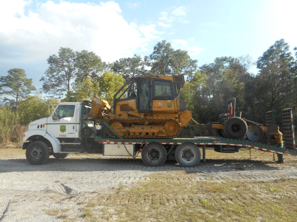 John Deere 650J dozer loaded on a ramp truck