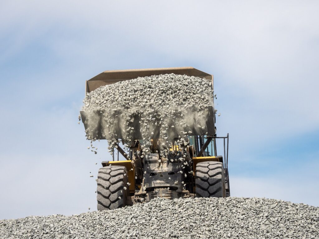 Komatsu WA380 wheel loader dumping a bucket of gravel