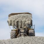 Komatsu WA380 wheel loader dumping a bucket of gravel