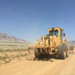 Motor grader working a gravel county road