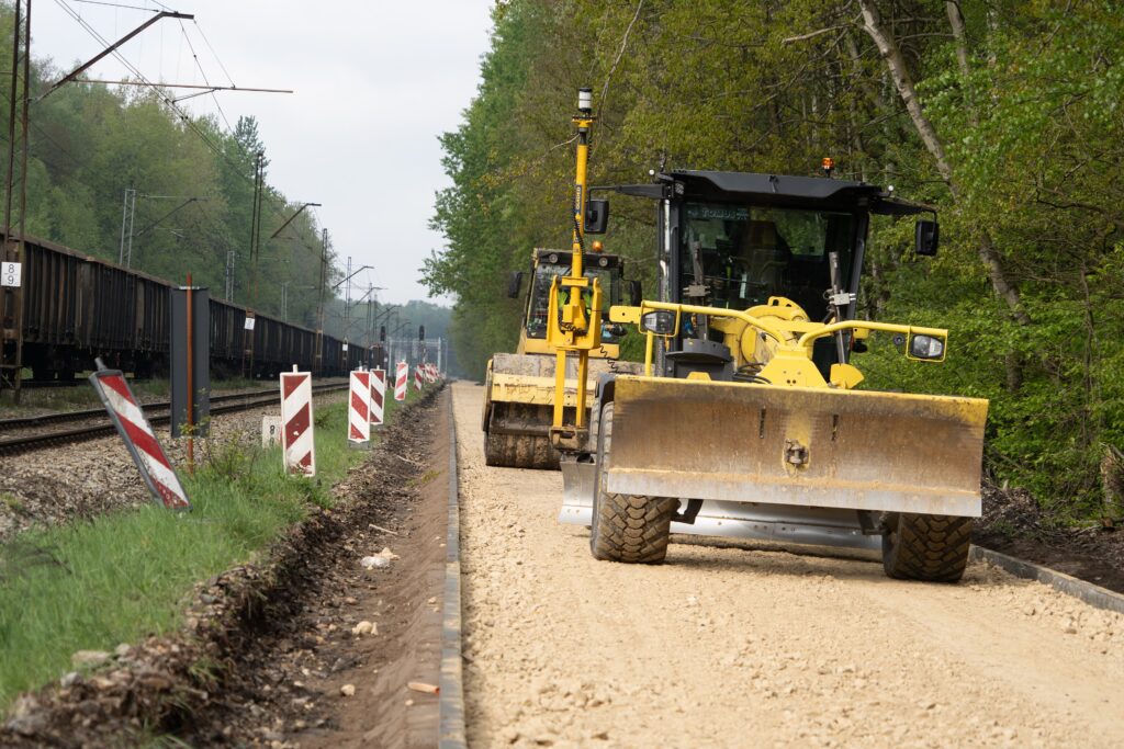 Motor grader leveling base material on a road construction project