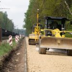Motor grader leveling base material on a road construction project