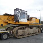 Tracked machine loaded on a multi-axle lowboy trailer