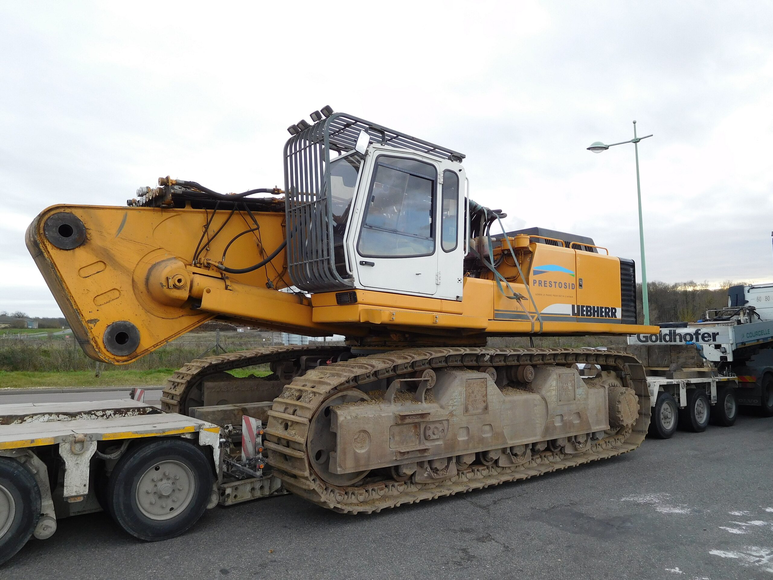 Tracked machine loaded on a multi-axle lowboy trailer