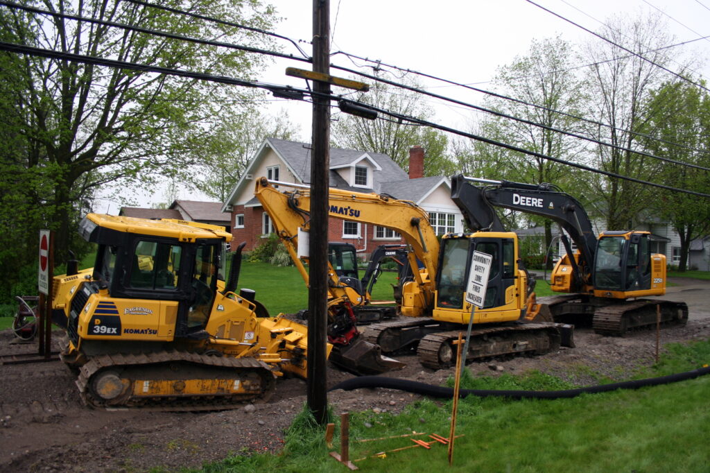 Crawler dozers and excavators lined up on an equipment lot
