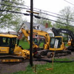 Crawler dozers and excavators lined up on an equipment lot